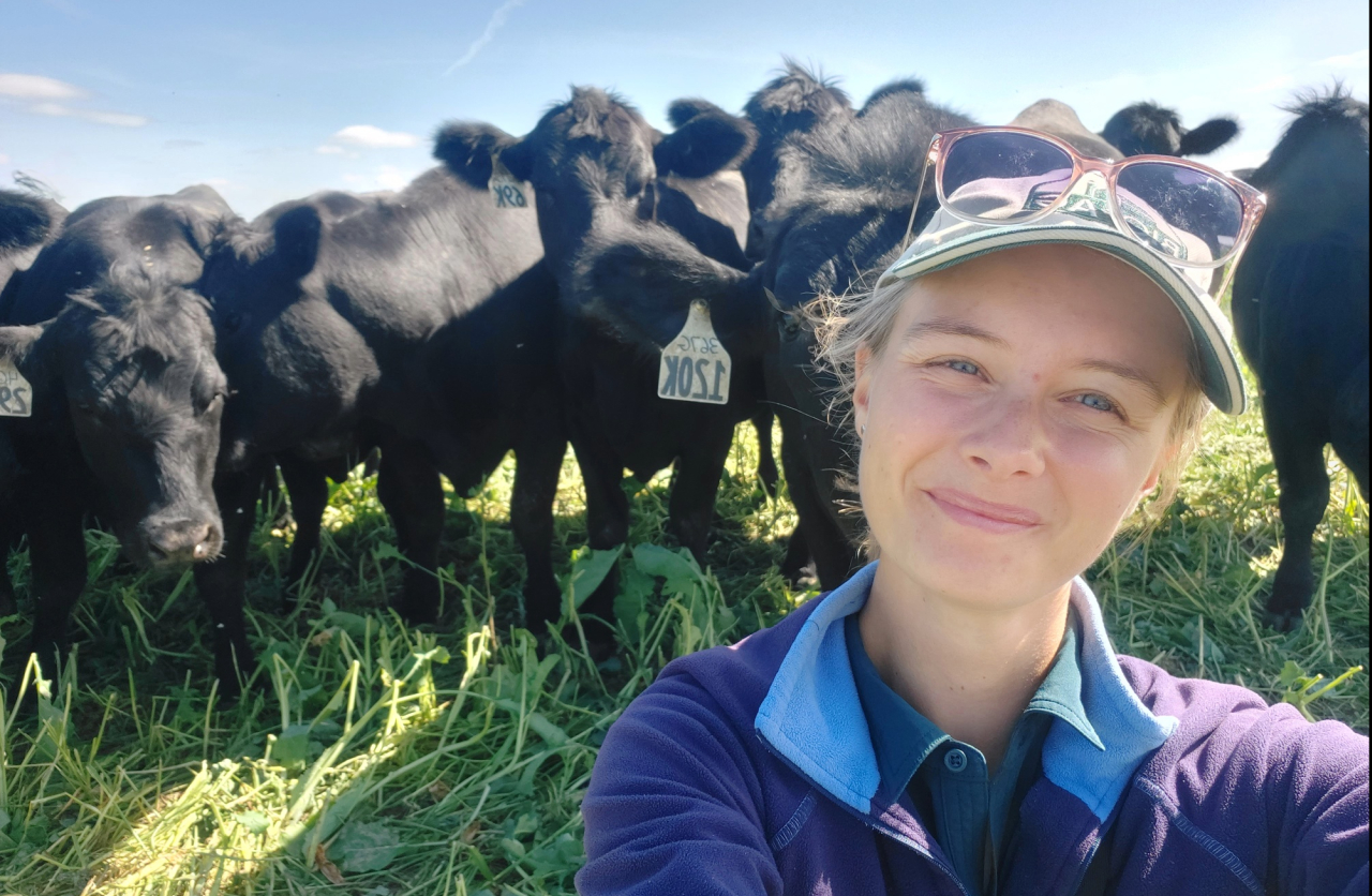 Caroline on pasture with her grazing cattle
